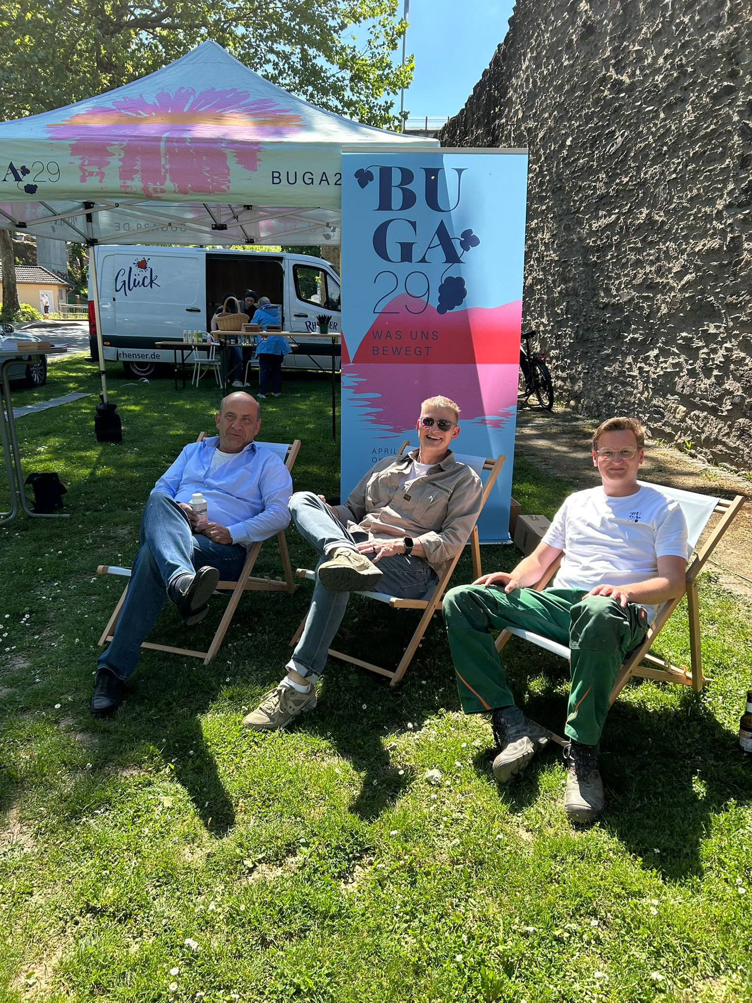 sliderimage-Die „Schöpp un Hack-Freunde Rhens“, Stadtbürgermeister Jörg Schüller und das Team der BUGA29 freuen sich mit interessiertem Bürger:innen auf das „Bunte Band Rhens“